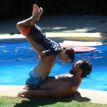 Father and son playing by the pool