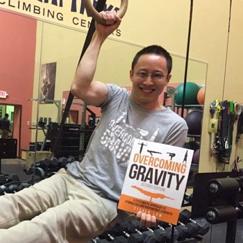 holding overcoming gravity book in gym