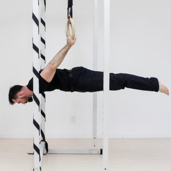 Ryan Hurst practicing a level on gymnastics rings