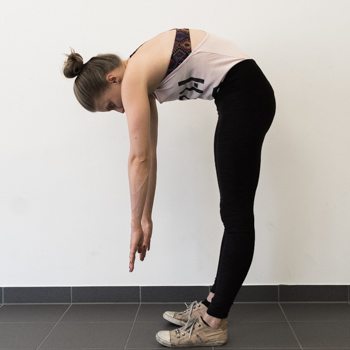 Alicia performing a forward fold stretch