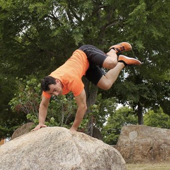 Man pushing off of a rock mid jump