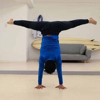 Chris doing a straddle handstand exercise