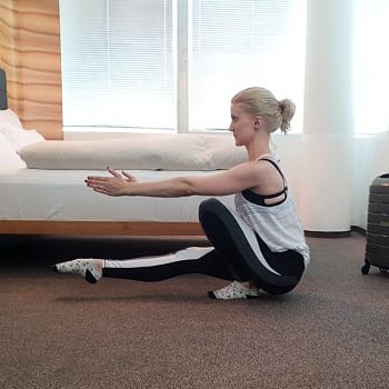 Alicia doing a pistol squat in a hotel room