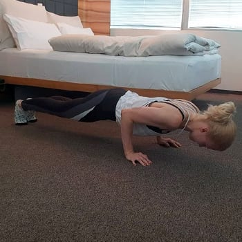 Alicia doing a push up in a hotel room