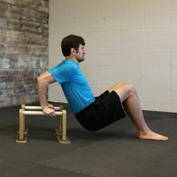 Jeff doing a dip exercise on parallettes