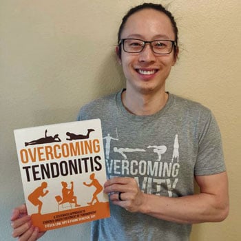 Steven Low holding a copy of Overcoming Tendonitis