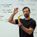 Ryan Hurst brandishing a banana while teaching handstands at a GMB Fitness seminar