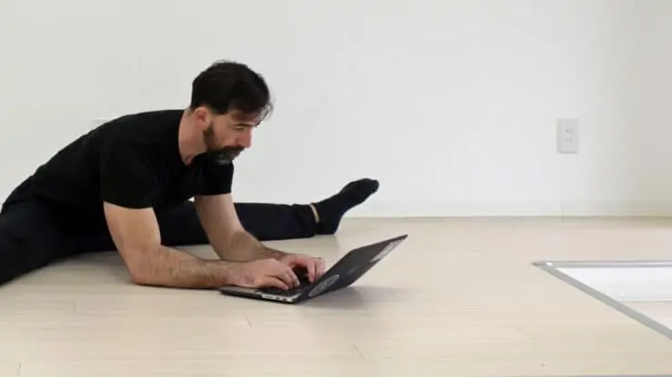 Ryan Hurst doing a split on the floor while gazing lovingly at the screen of his laptop, where he's is undoubtably writing a heartfelt love note to GMB newsletter subscribers
