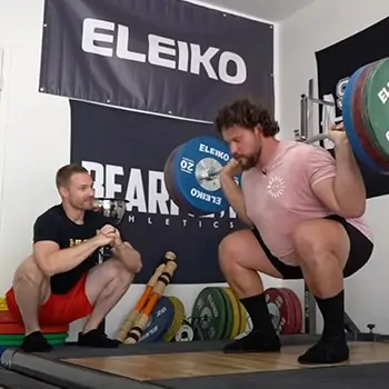 Dr. Aaron Horschig of Squat University coaching the reigning world's strongest man