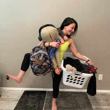 Mom doing chores carrying child