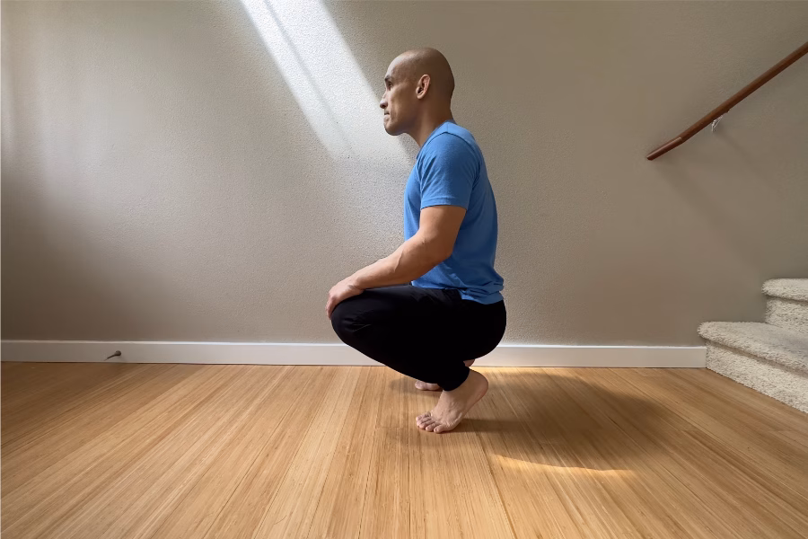 Man Squatting with Heels Up