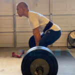 Man performing paused sumo deadlift