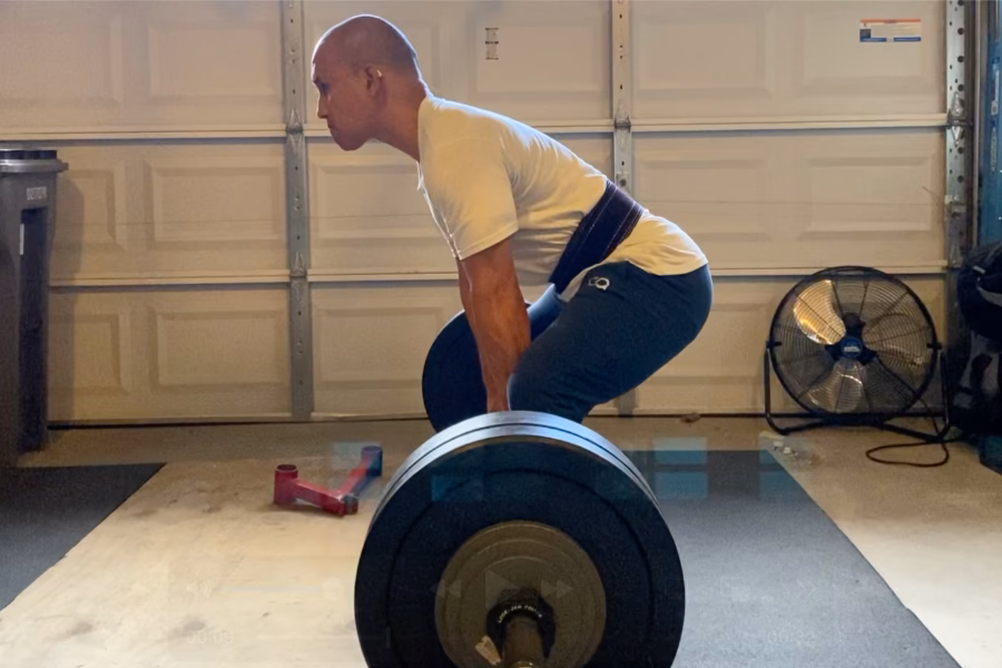 Man performing paused sumo deadlift