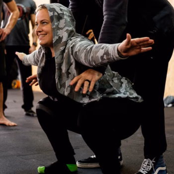 Woman practicing squats in a fitness seminar
